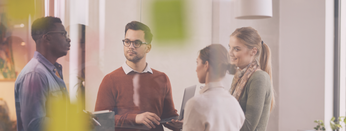 People standing around chatting in an office